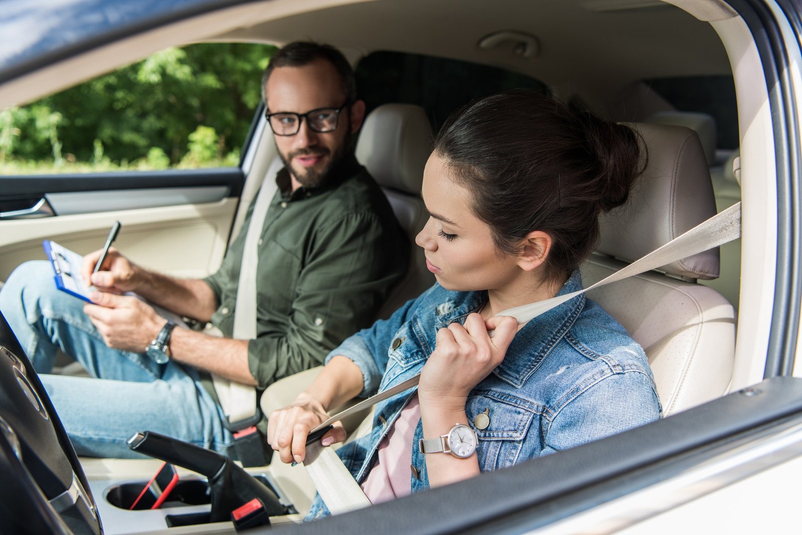 student-fastening-seat-belt-in-car-during-driving-test.jpg student-fastening-seat-belt-in-car-during-driving-test.jpg